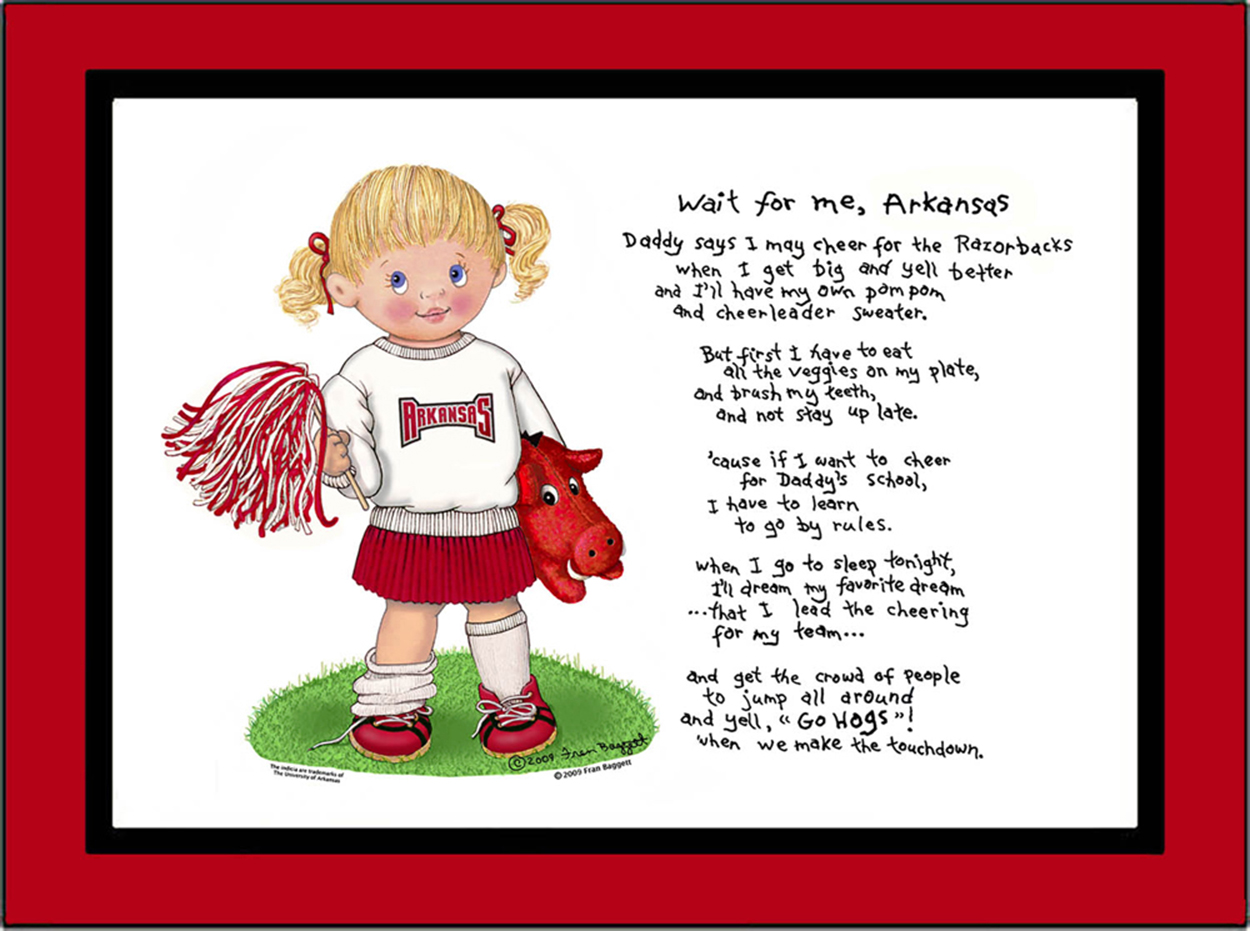 Arkansas toddler cheerleader standing in the grass with her bulldog puppy beside her. She is wearing red bows in her hair, a Arkansas sweatshirt, pleated skirt and sneakers with socks. She is holding a pom pom in one hand.